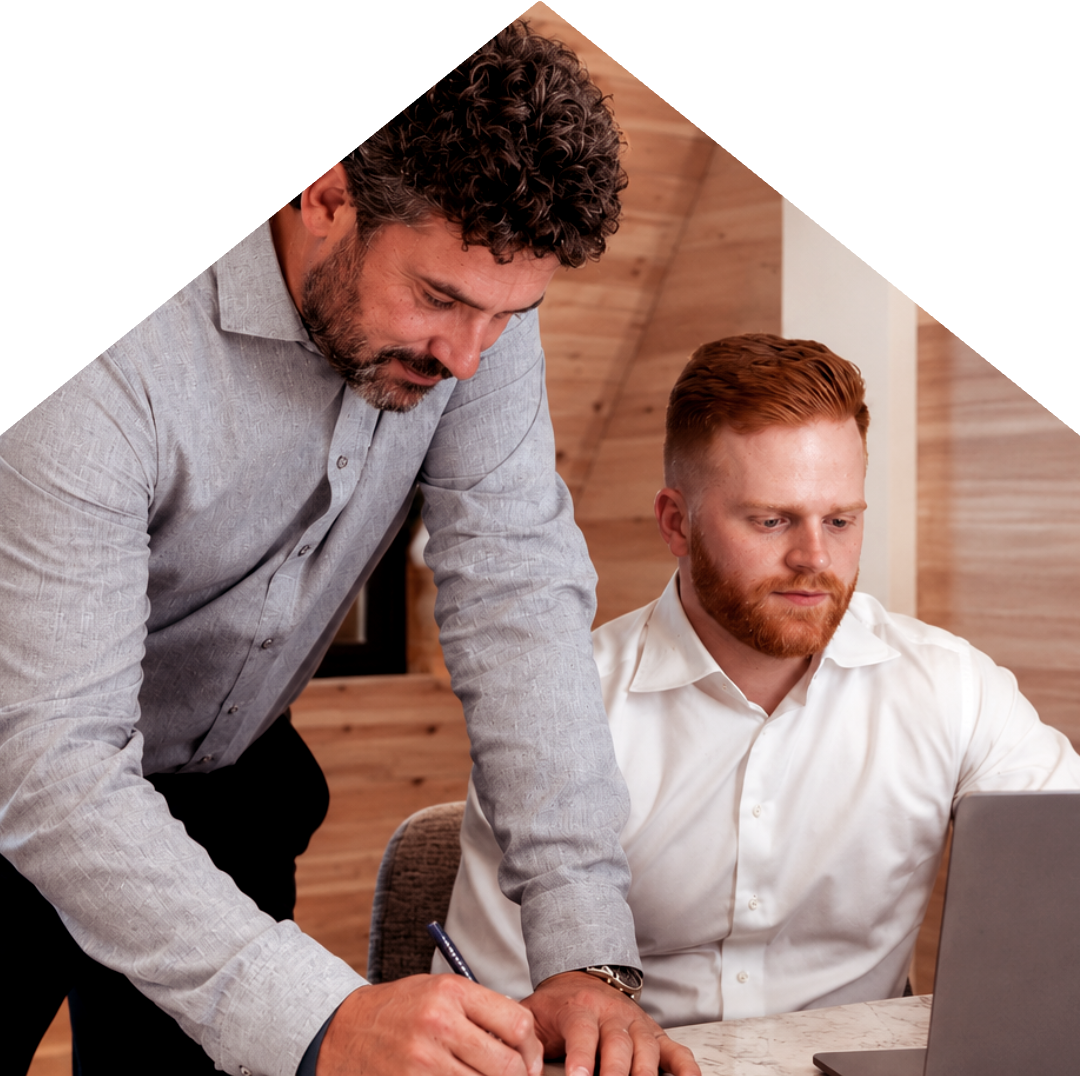 Two HEQ team members reviewing paperwork together