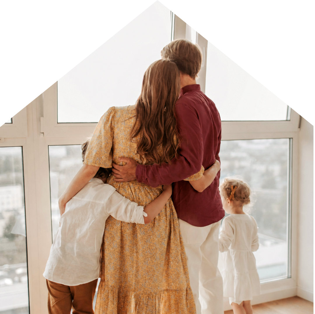 Family looking out the window of their home