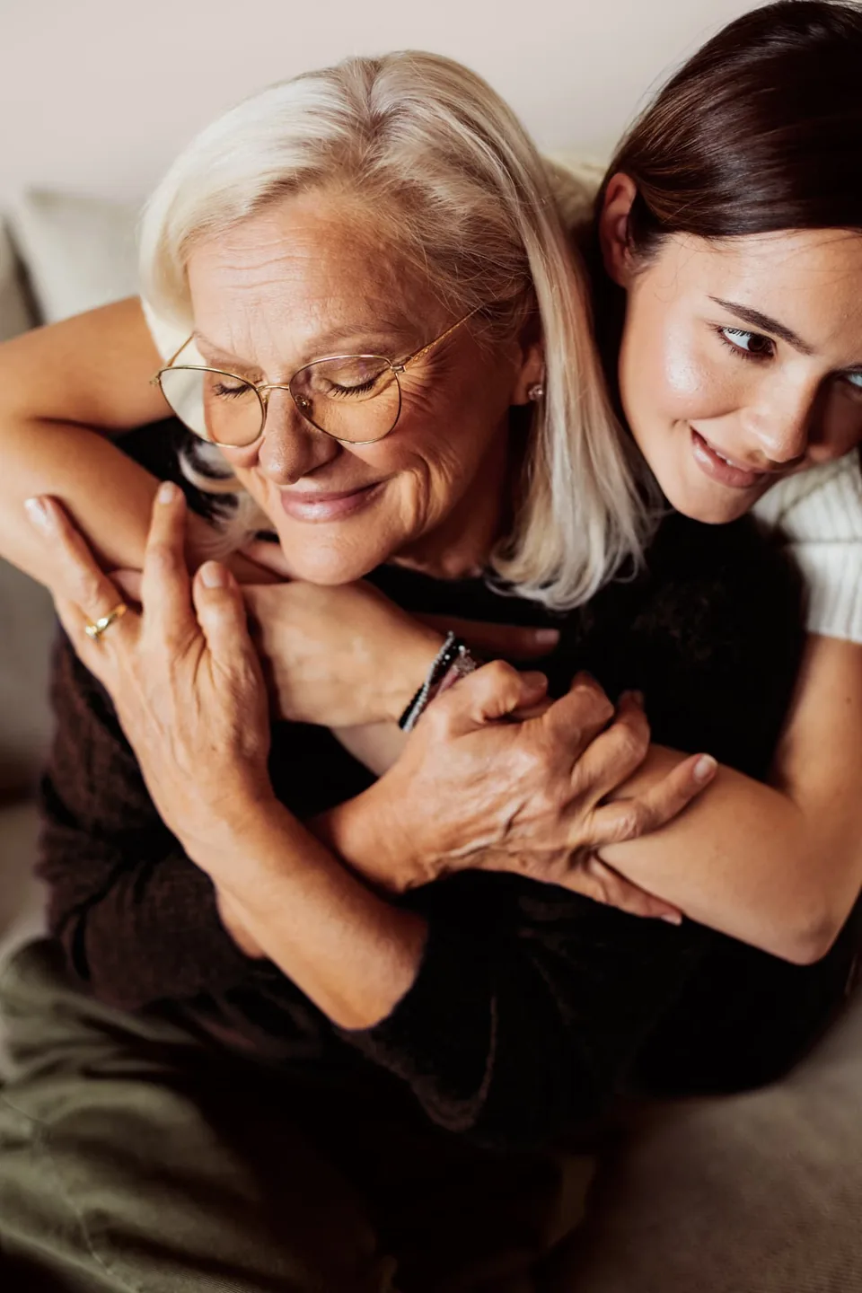 A daughter embracing her mother at home — the families HEQ partners with